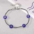 Detail of Bohemian evil eye bracelet featuring blue glass beads and adjustable silver chain - Black Rope Four Blue Eyes
