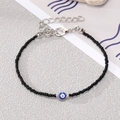 Detail of handmade beaded bracelet with blue evil eye charm and silver lobster clasp - Black Beads with Silver Blue Eye