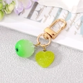 Creative fruit keychain with green lime ball and translucent heart pendant on gold clasp - Green Orange Heart Keychain