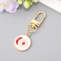 Detail of a golden evil eye keychain with white enamel and red crescent moon motifs - Round Moon Eye