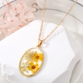 Detailed close-up of oval gold necklace with real yellow dried flowers in resin - 5# Oval Yellow Flower