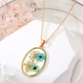 Detailed macro view of oval gold necklace featuring real blue and white dried flowers - 6# Oval Blue Flower