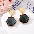 Detail view of hexagonal faceted grey crystal earrings with hammered gold metal studs - Black Hexagon