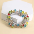 Close-up of colorful faceted beads on an elastic hair tie displayed on a white stand - White Rope Multicolor Crystal
