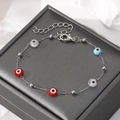 Close-up of a silver chain bracelet featuring colorful evil eye beads on a jewelry box - Colorful Eye Silver Bead Chain Bracelet (#6)