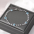 Chic pearl bracelet featuring blue evil eye charms and a silver adjustable metal chain - Artificial Pearl White & Blue Eye Chain Bracelet
