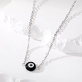 Minimalist evil eye necklace with silver chain on white stone, sharp shadows aesthetic - Black Eye