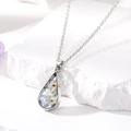 Close-up of a silver teardrop pendant necklace with preserved blue dried flowers - Blue Necklace