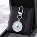 Silver evil eye elephant keychain with blue sand oil swirl detail on jewelry box display - Silver Elephant