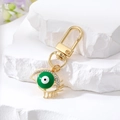 Llavero étnico dorado con ojo turco verde y brillantes diamantes de imitación blancos - Ojo de Pestaña Hueca / Verde