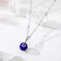 Detail of blue evil eye pendant with heart center on a silver chain necklace - Silver (Silver Chain Royal Blue)