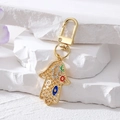 Golden Hamsa Hand keychain with colorful evil eye and sparkling crystal rhinestones - Gold Grid Hollow Colorful Round Palm