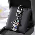 Sparkling Hamsa Hand keychain with blue evil eye charms and rhinestones on a black gift box - Silver Grid Hollow Colorful Round Palm