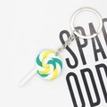 Close-up of green and yellow spiral resin lollipop keychain with silver metal ring - Green White And Yellow Lollipop