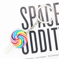 Detailed view of a colorful rainbow spiral lollipop keychain with silver metal ring chain - Fine Striped Rainbow Lollipop