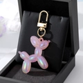 Pink holographic balloon dog keychain with gold carabiner in a luxury gift box display - Large Laser Pink