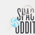 Macro shot of blue and white spiral rainbow lollipop keychain with silver metal chain - Blue And White Lollipop