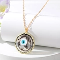Macro detail of Evil Eye pendant with gold wave edge and swirling marble resin texture - Black Round Eye