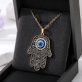 Vintage gold Hamsa Hand necklace with blue Evil Eye pendant and sparkling rhinestones - Gold Border Black Palm