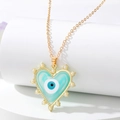 Detail of heart pendant necklace with blue evil eye design and white pearl border - Light Blue