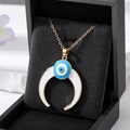 Golden Evil Eye necklace with white crescent moon pendant on black jewelry gift box - Gold White Moon