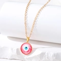 Detailed macro of Evil Eye pendant with red and white enamel on a gold chain - Small Round Eye / Red