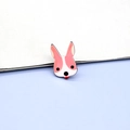 Macro detail of cartoon animal pin featuring a playful pink bunny badge with enamel finish - Corgi