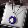 Classic blue glass evil eye pendant necklace with a minimalist black cord strap - Royal Blue With Yellow Eye