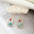 Detail view of rectangular resin earrings with embedded dried flowers and gold foil accents - Lake Blue Red Flower (With Pearl)