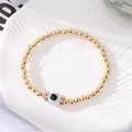 Beaded Evil Eye bracelet with golden round beads and sparkling rhinestone spacers - White Round Eyes