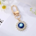 Detailed view of evil eye sun keychain with blue enamel and sparkling crystals - Royal Blue Enamel Round Eye With Rhinestone
