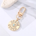 Golden Evil Eye keychain with blue crystal and sunburst rhinestone charms - Round Base Green Resin Eye