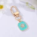 Macro detail of mint green enamel keychain with shimmering rhinestone star charm - Lake Blue Enamel Star