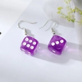 Close-up of trendy transparent purple resin dice earrings with silver metal hooks - Purple