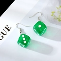 Detail of green resin dice earrings featuring semi-transparent texture and silver ear hooks - Green