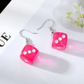 Detailed view of pink translucent resin dice earrings with white dots and silver hooks - Rose Red