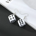 Minimalist white dice earrings with silver metal hooks on a stylish black and white background - White