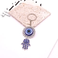 Detailed close-up of vintage silver Hamsa Hand and Evil Eye keychain with blue rhinestones - Hamsa Hand Style / Silver/Blue
