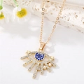 Macro view of gold evil eye necklace with blue rhinestones and small white pearls - Evil Eye Style
