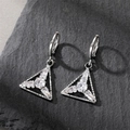 Detailed view of silver triangle drop earrings with cubic zirconia on stone background - Triangle Ear Buckle
