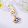 Goldener Evil Eye Schlüsselanhänger mit blauem Harzauge und Strasssteinen für Taschen - Blaues Böser Blick (Emaille-Stil)