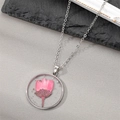 Elegant round silver necklace with pink dried flower specimen and shimmering silver flakes - Pink Daisy