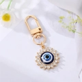 Golden Evil Eye keychain charm featuring blue resin eye and sparkling crystal accents - Sunflower Eye with Rhinestones