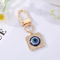 Golden Evil Eye keychain with square rhinestone frame and blue crystal center - Square Eye with Rhinestones