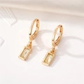 Detailed macro shot of gold square crystal drop earrings with polished rectangle pendants - Yellow