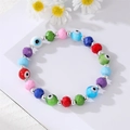 Bohemian colorful beaded evil eye bracelet with faceted resin charms on white background - Colorful