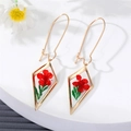 Detail view of gold rhombus earrings with real red dried flowers in clear resin - Red