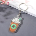Macro view of a coffee cup acrylic keychain with Bitter Sweet logo on grey texture - Ice Cream Keychain