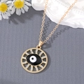 Detailed close-up of golden Evil Eye pendant necklace with sparkling crystal rhinestones - Black