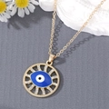 Golden Evil Eye necklace with crystal rhinestones on a radial sunburst pendant - Blue